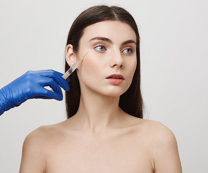 shirtless woman holding her breast in a model image